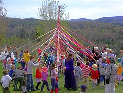 The Community joins in dancing around the Maypole